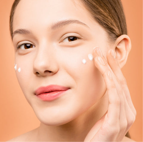 Image of woman with face moisturized with cream